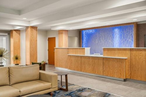 a lobby with a couch and a large screen at Fairfield Inn and Suites by Marriott Birmingham Fultondale / I-65 in Fultondale
