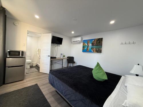 a small bedroom with a bed and a kitchen at Motel Saint Bruno in Saint-Bruno-de-Montarville