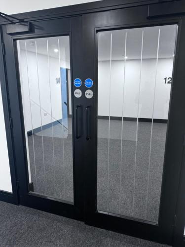 an open glass door in an office building at New 2 Bed Apartment in Royston High St in Royston