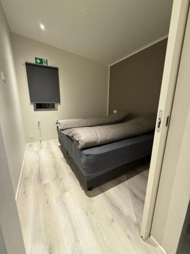 a bedroom with a bed and a flat screen tv at Kirkjufell View Cottages in Grundarfjordur