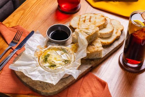 a wooden table with a plate of food with bread at Holiday Inn Newcastle-Jesmond by IHG in Newcastle upon Tyne