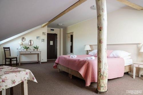 a bedroom with two beds and a table with a desk at Gościniec Winnica in Sławica