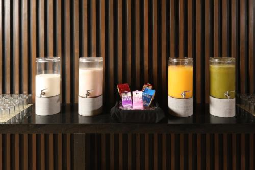 four glasses of different types of drinks on a shelf at Holiday Inn Resort Mazatlan by IHG in Mazatlán