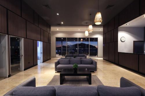 a large living room with couches and a tv at Holiday Inn Resort Mazatlan by IHG in Mazatlán