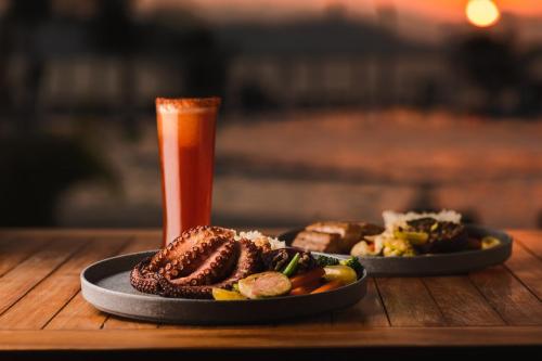 a plate of food and a drink on a table at Fiesta Americana Acapulco Villas in Acapulco