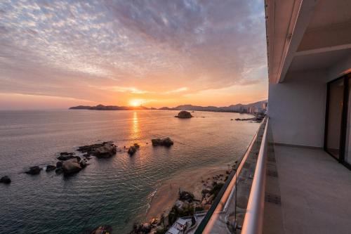 a view of the ocean from a balcony at sunset at Fiesta Americana Acapulco Villas in Acapulco