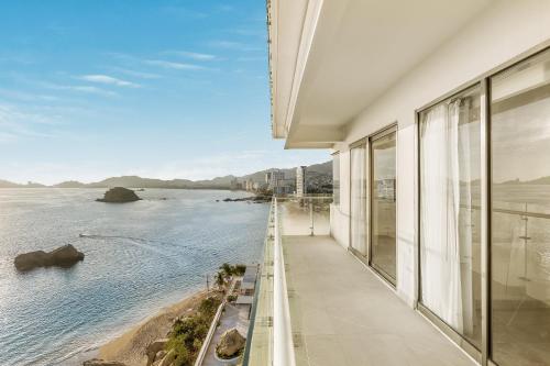 a balcony with a view of the water at Fiesta Americana Acapulco Villas in Acapulco