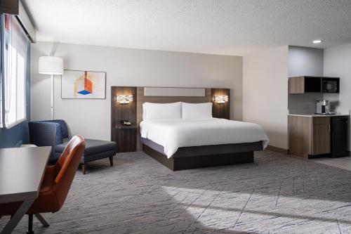 a hotel room with a bed and a desk at Holiday Inn Express & Suites Midwest City by IHG in Midwest City