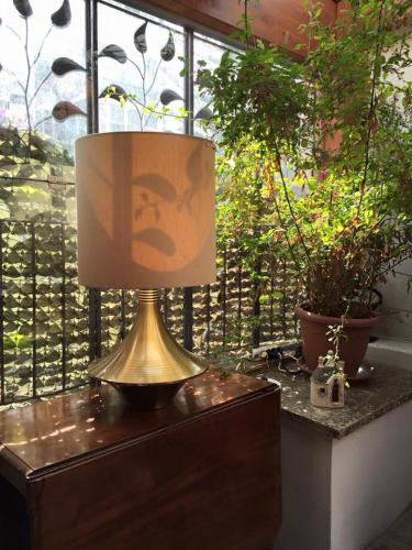 a lamp sitting on top of a dresser next to a window at Bed and Breakfast Oz in Bari