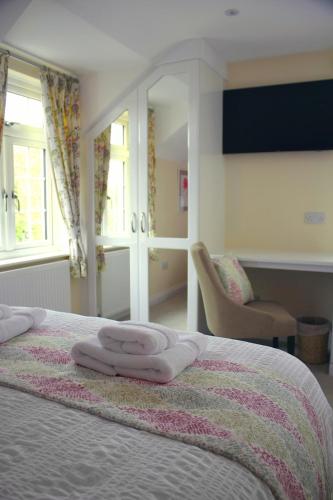 a bedroom with a bed with two towels on it at The Anchor Inn in Thornbury
