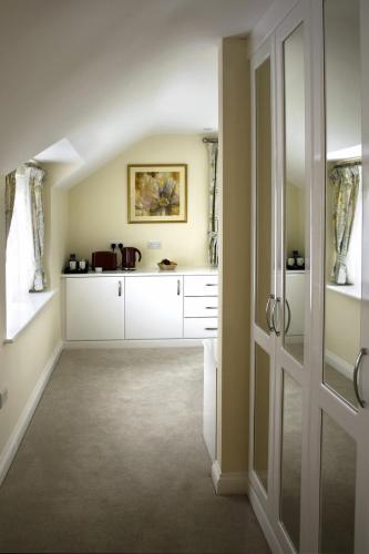 a hallway with a room with white cabinets at The Anchor Inn in Thornbury