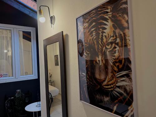 a picture of a tiger on the wall in a bathroom at Hosting Dreams Attics - Duomo in Milan