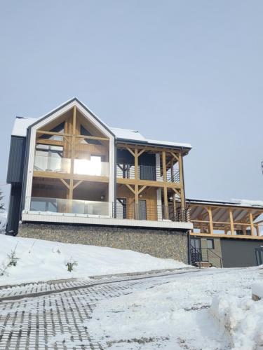 a house with a large window on the side of it at Шале Green Land in Bukovel