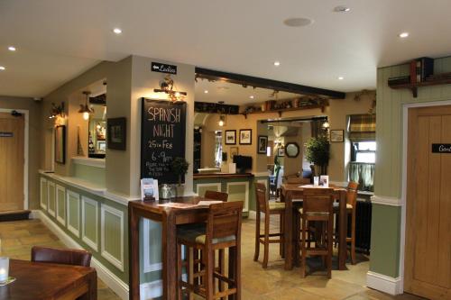 a dining room with tables and chairs in a restaurant at Blue Bell Country Inn in Knaresborough