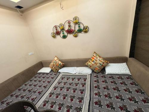 a room with a couch with blankets and pillows at Mathura Bliss Resort Villa in Mathura