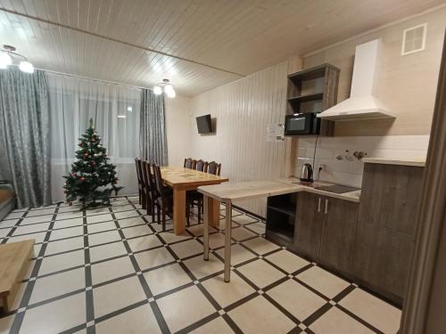a kitchen with a table and a christmas tree in it at Приватна садиба Соломія in Bukovel