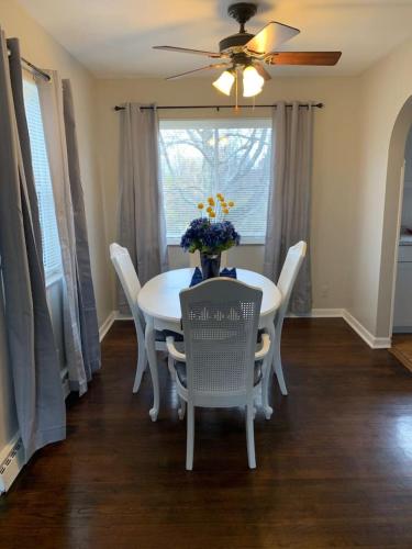 a dining room with a white table and chairs at Lovely Retreat Backyard With Deck and entertain room in Mason