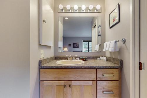a bathroom with a sink and a mirror at Bayfront Retreat A in Port Ludlow