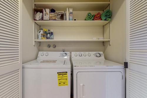 a small kitchen with a stove and a refrigerator at Bayfront Retreat A in Port Ludlow