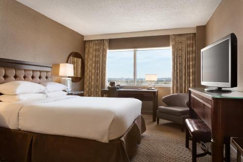 a hotel room with a bed and a television at The Park Hotel at Meadowlands in East Rutherford