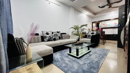 a living room with a couch and a table at Premium 3 Bedroom Independent Villa in Indore