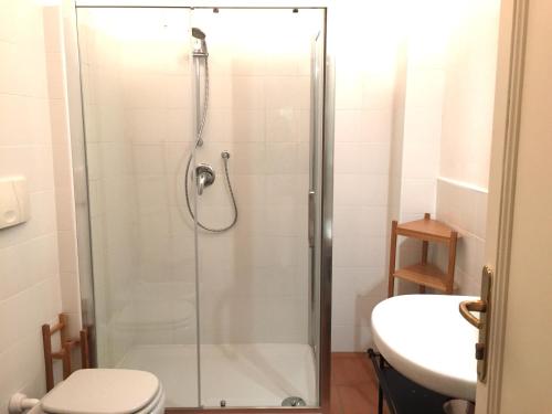 a bathroom with a shower and a toilet and a sink at La Maison in Bergamo