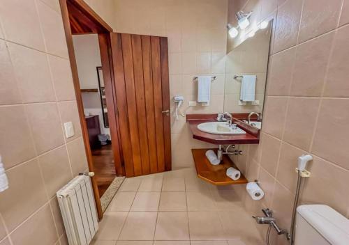 a bathroom with a sink and a mirror at Pousada Victoria Villa By Nacional Inn - A 800 metros da Vila Capivari in Campos do Jordão