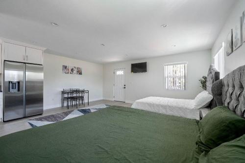 a living room with a couch and a refrigerator at Prestige Studio Haven at Burbank in Burbank