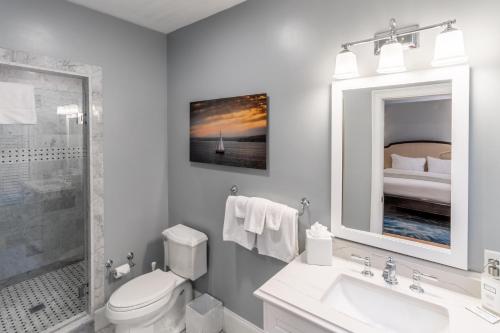 a white bathroom with a sink and a toilet at The Outlook Inn in Newport