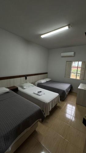 Postel nebo postele na pokoji v ubytování Hotel Brasil