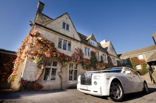 a white limousine parked in front of a house at Hatton Court Hotel in Gloucester
