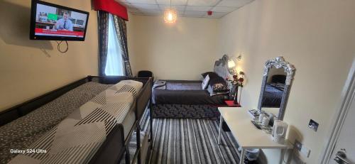 a small room with a bed and a couch at BUKHARI Hotel in Blackpool