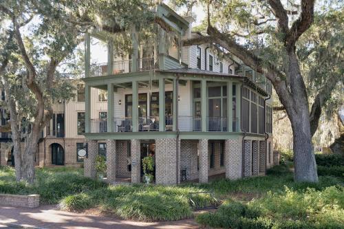 a large brick house with a balcony and trees at River View 3 Bedroom Wilson Village Home 70 in Bluffton
