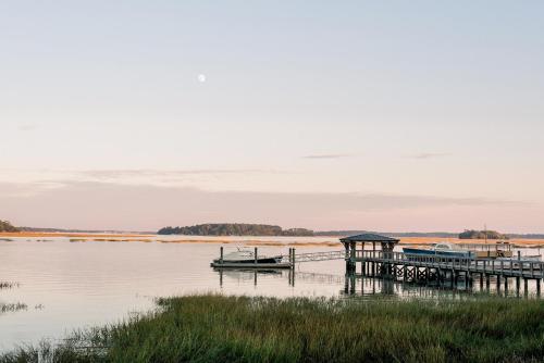 a dock with a boat on a body of water at River View 3 Bedroom Wilson Village Home 70 in Bluffton