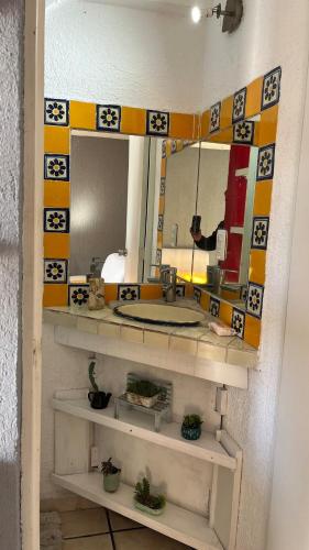 a person taking a picture of a bathroom mirror at Casa en Cuernavaca Casa Luz in Cuernavaca