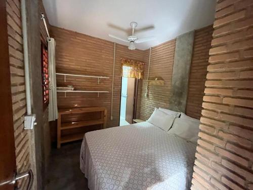 a bedroom with a bed and a wooden wall at Casa dos Sonhos em São Miguel dos Milagres in São Miguel dos Milagres