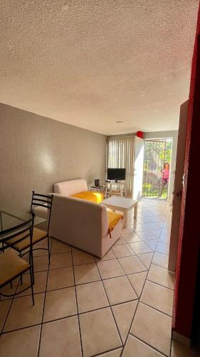 a living room with a couch and a table at Casa en Cuernavaca Casa Luz in Cuernavaca