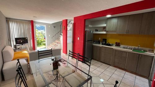 a kitchen with a glass table in a room at Casa en Cuernavaca Casa Luz in Cuernavaca
