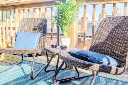 two chairs and a table with wine glasses on a porch at Jennifer's Getaway Stunning Views & Private Deck in Providence