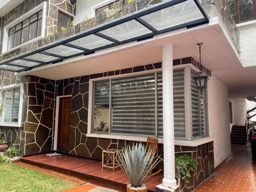 a house with a window with blinds on it at Napoles Clasico in Mexico City