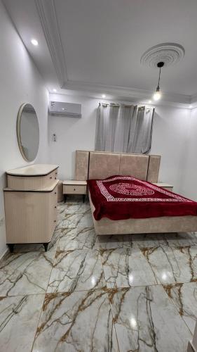 a bedroom with a bed and a vanity and a mirror at Appartement S3 CHIC à Mahdia 2étages in Mahdia