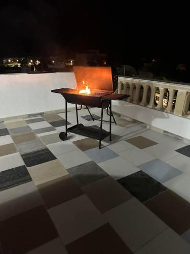 a table with a candle on top of a tiled floor at Appartement S3 CHIC à Mahdia 2étages in Mahdia