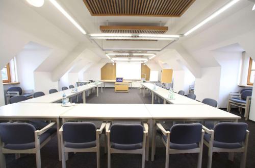 an empty room with a long table and chairs at Hotel-Landgasthof Schuster in Greding