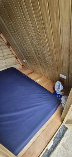 a bed in a room with a wooden ceiling at Ecox Hostel Cabanas 2 in Penha