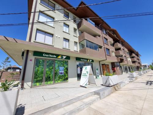 a building with a sign in front of it at Departamento Corporativo II Talca Las Rastras ' Valles del Country - RENTCOVAC - Factura Inmediata in Talca