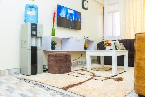 a living room with a table and a tv at Bamburi BnB in Mombasa