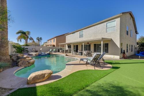 a backyard with a swimming pool and a house at Putting Green, Pool and Spa Home in Queen Creek! in Queen Creek