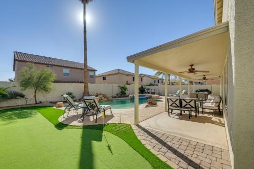 a patio with a table and chairs and a pool at Putting Green, Pool and Spa Home in Queen Creek! in Queen Creek