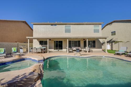a swimming pool in front of a house at Putting Green, Pool and Spa Home in Queen Creek! in Queen Creek
