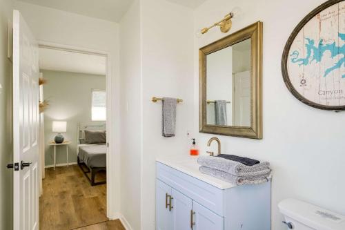 a bathroom with a sink and a mirror on the wall at Sunset Ridge 2King Beds Lake Hot Tub Pool in Canyon Lake
